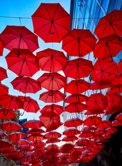 Fototapeta na wymiar Red Umbrellas In the Air