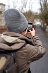 tourist woman taking pictures with mobile phone