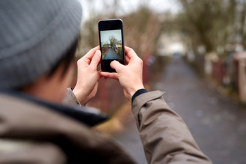 tourist woman taking pictures with mobile phone