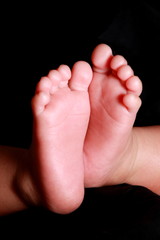 Closeup Picture of baby foot photographed against black background