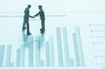 miniature business man on the graph