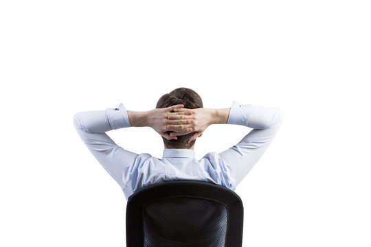 Rear view of the relaxing businessman in the office chair. Isolated.