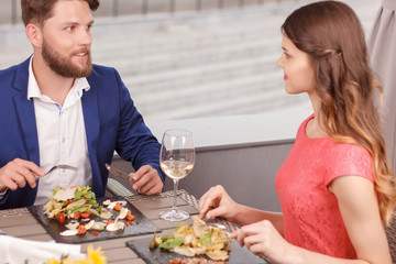 Pleasant couple during date in restaurant 