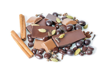 Cracked chocolate bar, dragee and  spices isolated on white. Sel