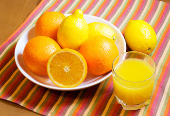 Oranges, lemons and glass of orange juice