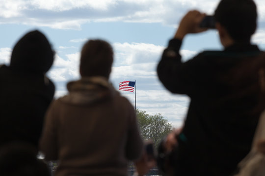Travelers looking at the US flag