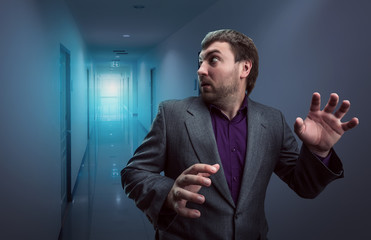 Scared businessman in the corridor
