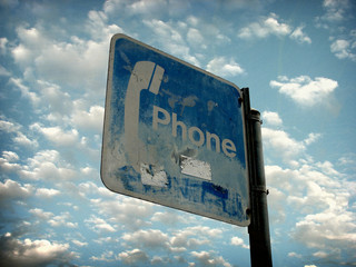 Naklejka premium aged vintage photo of public phone sign