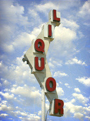 aged and worn vintage photo of old liquor store sign