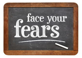Obraz premium Face your fears advice on blackboard