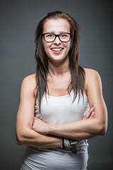 Sexy young retro woman  wearing glasses over gradient grey background.
