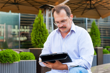 Middle age businessman using tablet