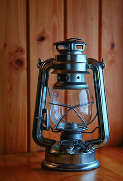 Old kerosene lantern on background wood
