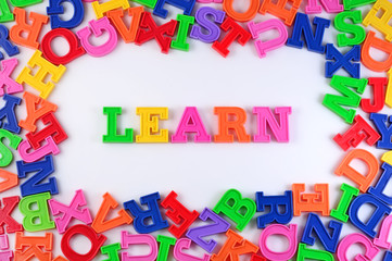 Learn written by plastic colorful letters on a white