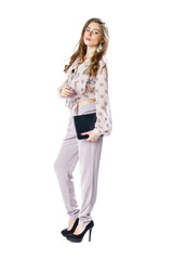 Fototapeta premium Young beautiful brunette woman in a blouse and pants