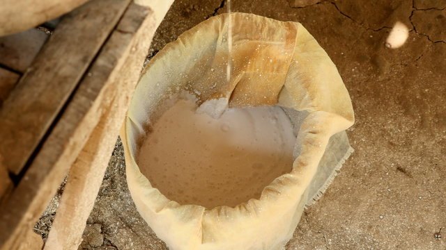 Close-up on soaked rice flour collected out of wet rice grinding with millstone