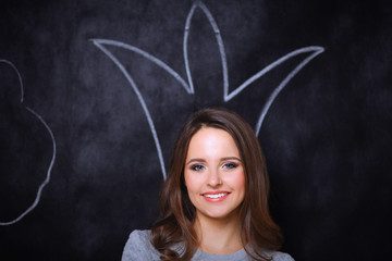 Closeup portrait of beautiful young girl with painted crown