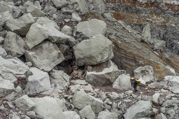worker carry sulfur for selling at Kawah Ijen volcano crater