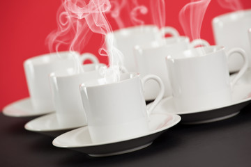 Obraz na płótnie Canvas Espresso cups with steaming hot coffee
