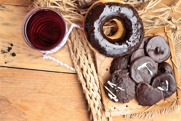 Chocolate donut of delicious on wood background.