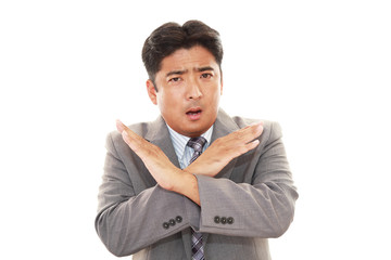 禁止の意思表示をするビジネスマン