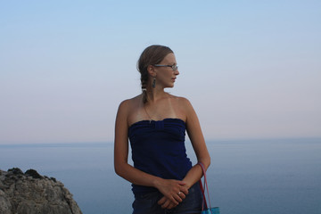 Portrait of a beautiful woman on the sea sunset.