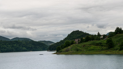  Clear mountain lake and rocky mountains in late summer.