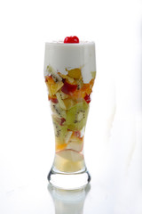 A fruit salad juice with whipping cream