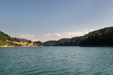  Clear mountain lake and rocky mountains in late summer.