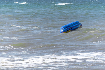 capsized inflatable boat  in the sea