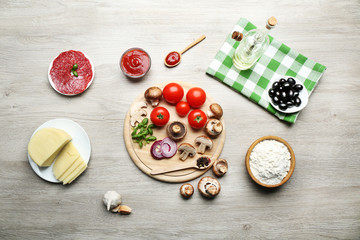 Ingredients for cooking pizza on wooden table, top view