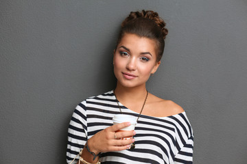 Portrait of young woman with cup tea or coffee