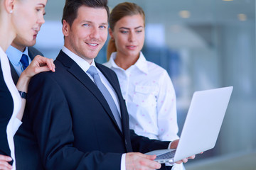 Group of  business people doing presentation with laptop during