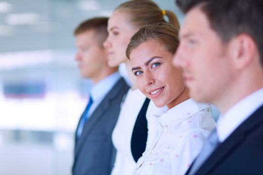 Smiling successful business team standing in office