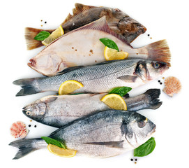 Fresh fishes with spices isolated on white