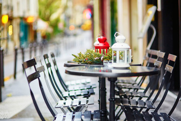 Tables of a Parisian cafe decorated for Christmas
