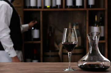 Bartender working at counter on bar background