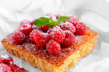 Fresh pie with raspberry and sugar on parchment, closeup