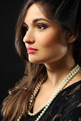 Retro style portrait of young woman on dark background