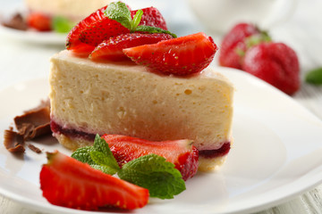 Delicious cheesecake with berries on table close up