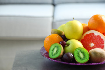 Fresh fruits on table in living room, close up