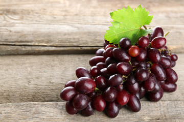 Fresh ripe grapes on old wooden table