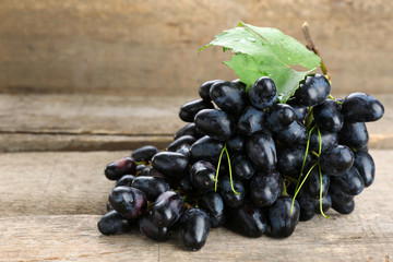 Fresh ripe grapes on old wooden table