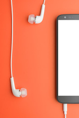 Fototapeta premium Smartphone with connected headphones