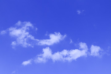 Blue sky with tiny clouds
