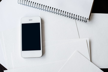 Smartphone and clean white paper