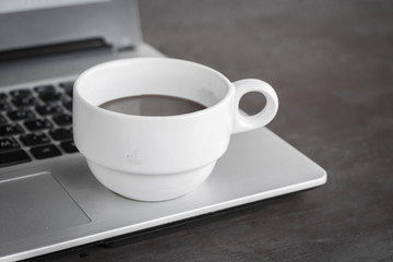 coffee cup put on laptop