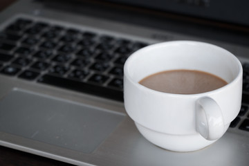 coffee cup put on laptop