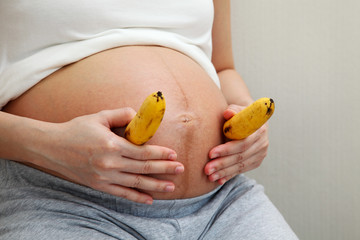 Pregnant Woman Holding Bananas