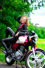 Plakat Biker girl in leather jacket on a motorcycle